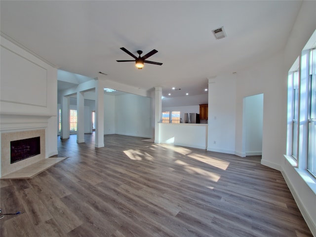 unfurnished living room with wood-type flooring and plenty of natural light