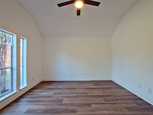 spare room with wood-type flooring, ceiling fan, and vaulted ceiling