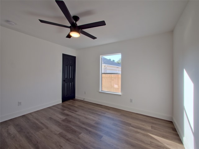 empty room featuring wood-type flooring and ceiling fan