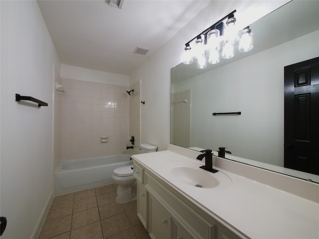 full bathroom featuring vanity, tile patterned flooring, toilet, and tiled shower / bath combo