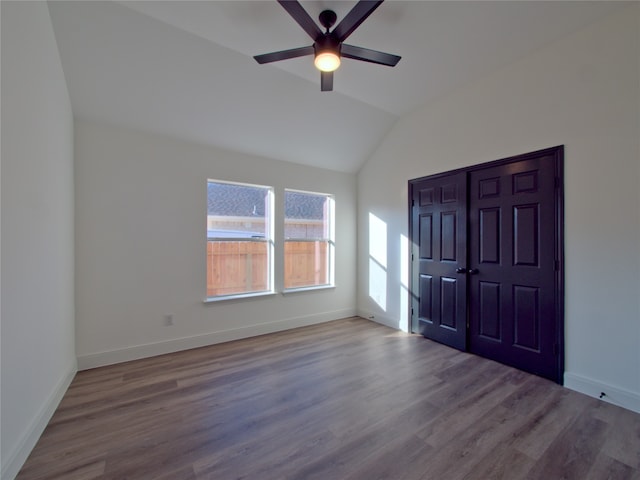 interior space featuring hardwood / wood-style floors, ceiling fan, and vaulted ceiling