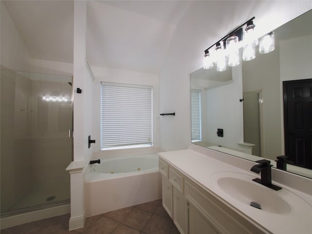 bathroom featuring vanity, plus walk in shower, vaulted ceiling, and tile patterned flooring