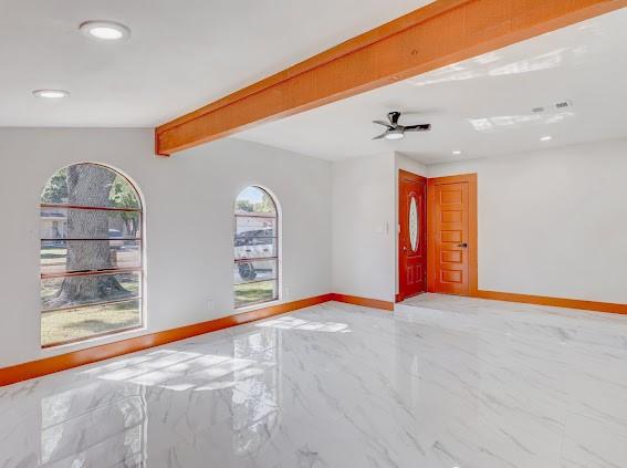 7311 La Mesa Dr, Houston, TX 77083 - spare room featuring recessed lighting, light marble finish floors, baseboards, ceiling fan, and beamed ceiling