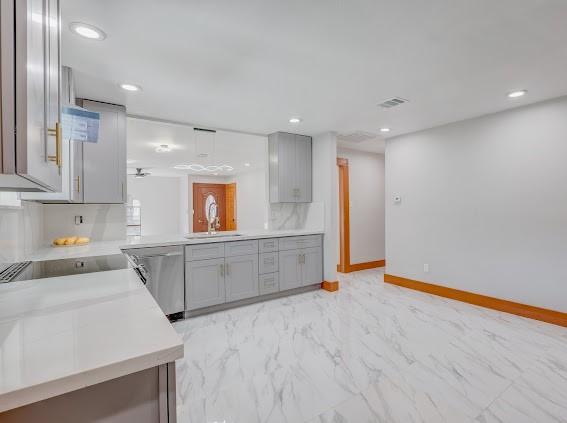 7311 La Mesa Dr, Houston, TX 77083 - kitchen with dishwasher, gray cabinets, light marble finish flooring, light countertops, and baseboards