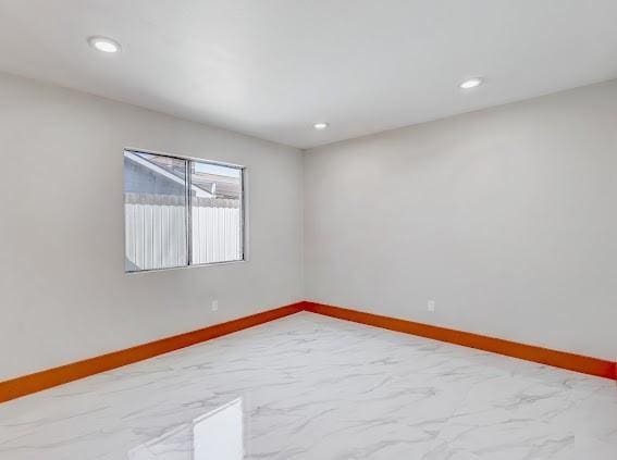 7311 La Mesa Dr, Houston, TX 77083 - spare room with baseboards, recessed lighting, and marble finish floors
