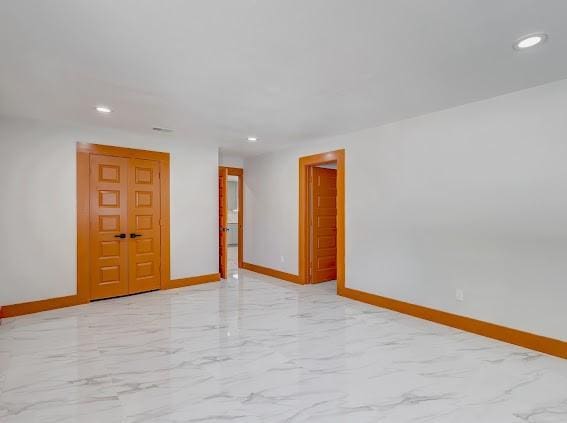 7311 La Mesa Dr, Houston, TX 77083 - empty room featuring baseboards, light marble finish flooring, and recessed lighting
