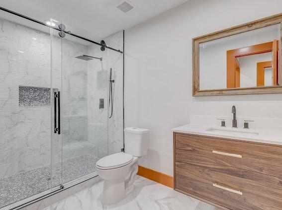 7311 La Mesa Dr, Houston, TX 77083 - full bath featuring marble finish floors, toilet, vanity, and a stall shower