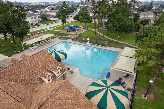 view of pool featuring a patio and a lawn