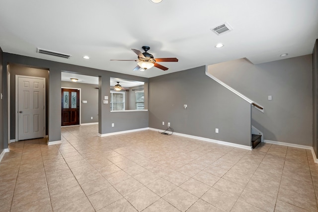 unfurnished room with ceiling fan and light tile patterned flooring