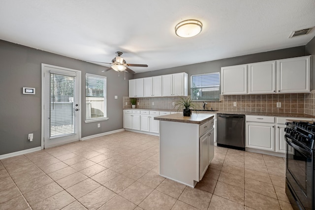 kitchen with a center island, dishwasher, black range oven, and white cabinets