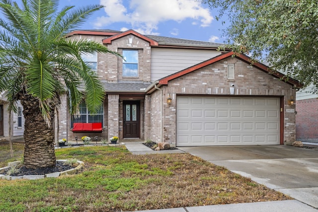 view of front of property with a front yard and a garage