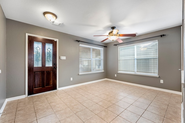 tiled entrance foyer with a wealth of natural light and ceiling fan