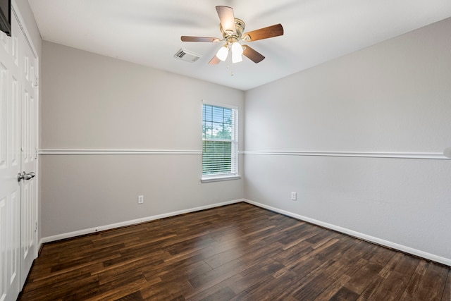 unfurnished room featuring ceiling fan and dark hardwood / wood-style flooring