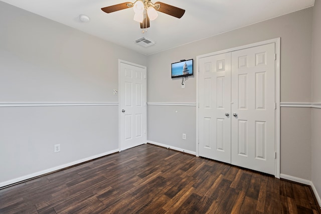 unfurnished bedroom with a closet, ceiling fan, and dark hardwood / wood-style floors