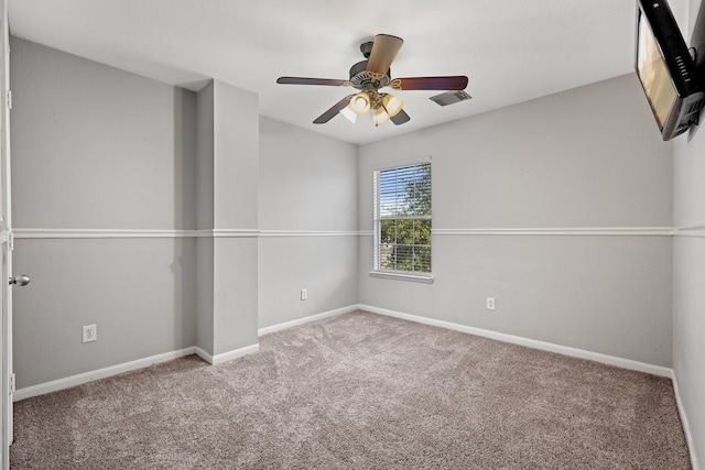 carpeted spare room with ceiling fan