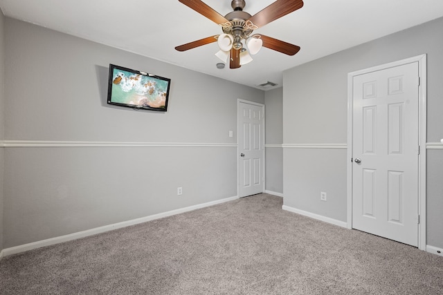 carpeted spare room featuring ceiling fan