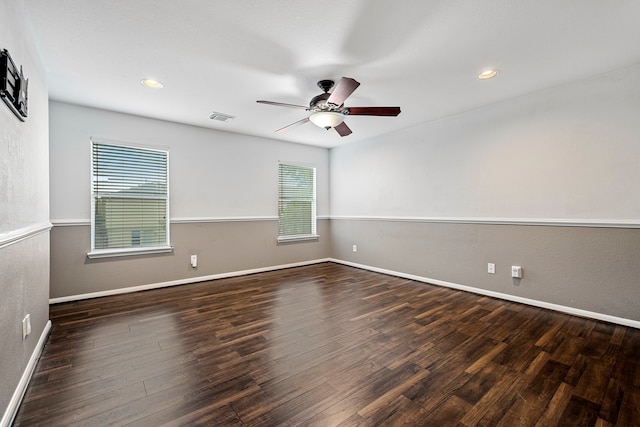 empty room with ceiling fan and dark hardwood / wood-style floors