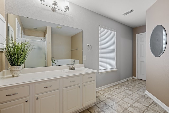 bathroom with vanity and walk in shower