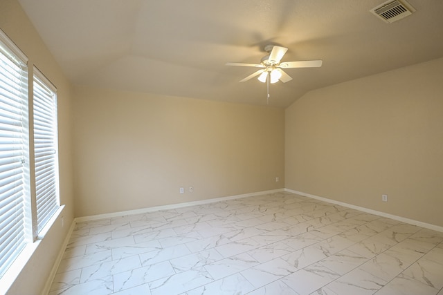 spare room with ceiling fan and lofted ceiling