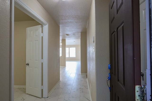 corridor with a textured ceiling