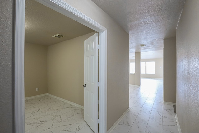 corridor with a textured ceiling