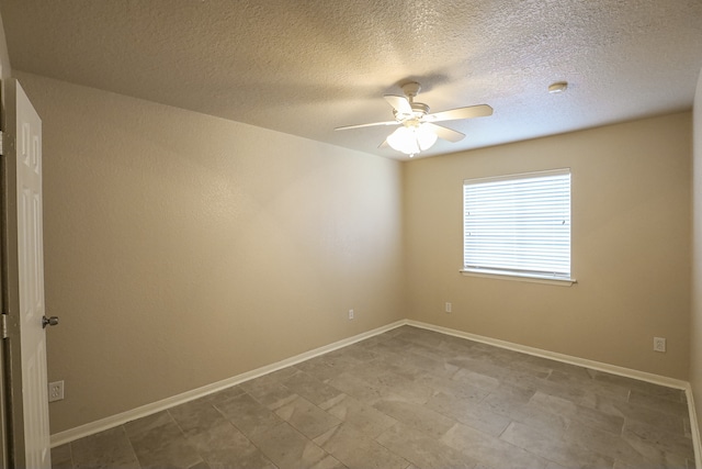 spare room with ceiling fan and a textured ceiling