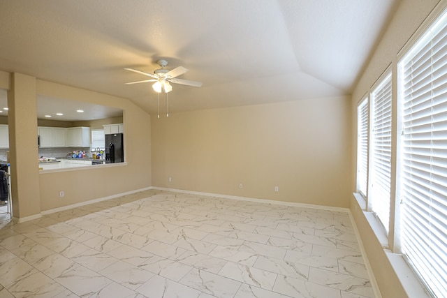 unfurnished living room featuring ceiling fan and lofted ceiling