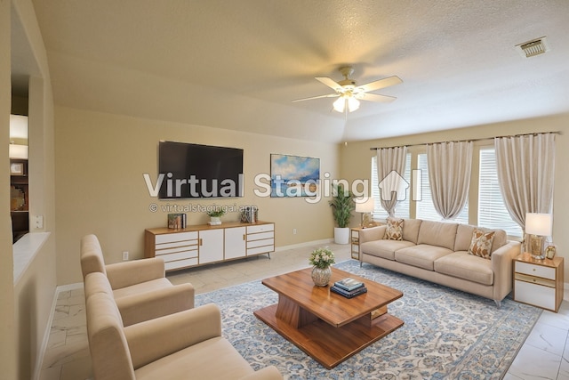 living room with ceiling fan and a textured ceiling