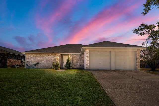 ranch-style house with a lawn and a garage