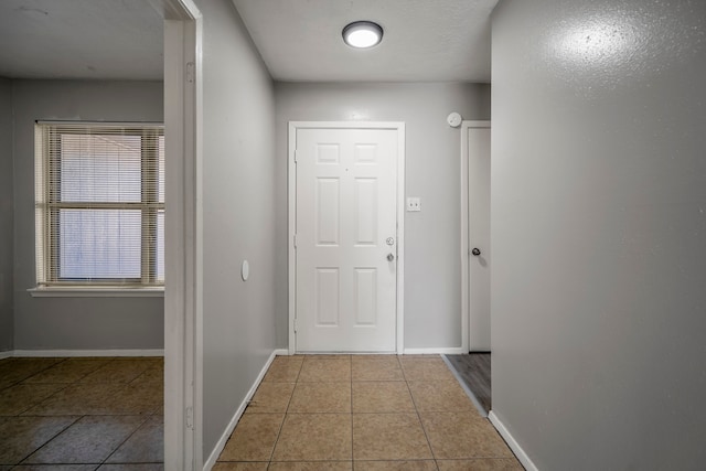 hall featuring light tile patterned flooring