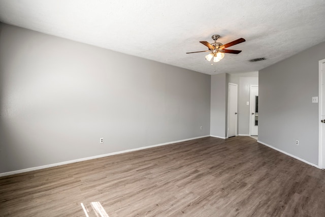 spare room with a textured ceiling, hardwood / wood-style flooring, and ceiling fan