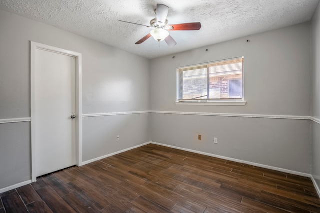 unfurnished room featuring ceiling fan, dark hardwood / wood-style floors, and a textured ceiling