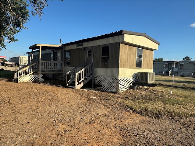 rear view of house featuring cooling unit