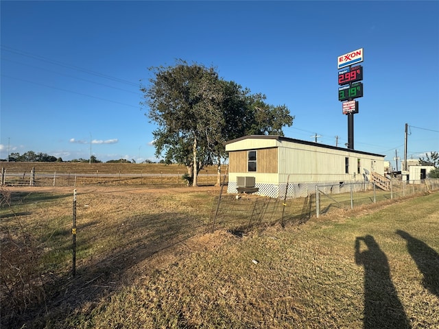 view of yard featuring a rural view and central AC