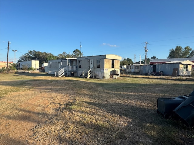 rear view of house with a yard