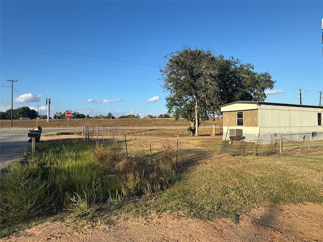 view of yard with a rural view