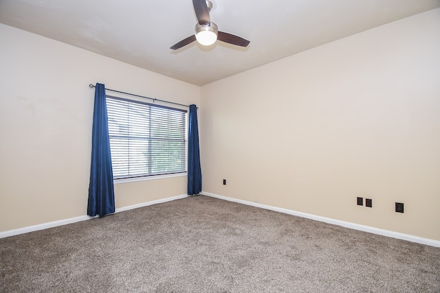 carpeted spare room featuring ceiling fan