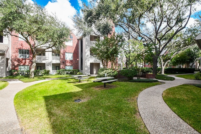 view of home's community featuring a lawn