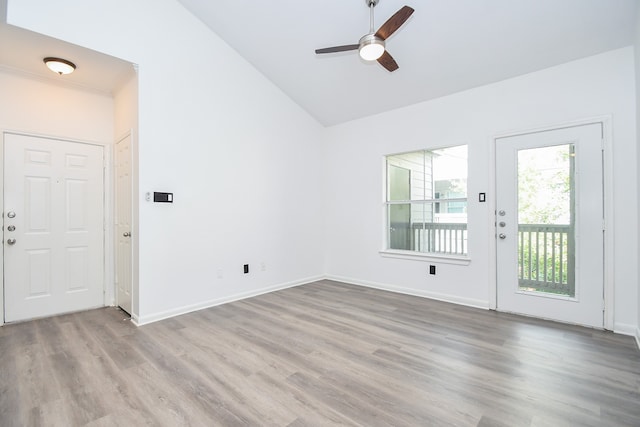 interior space with ceiling fan, vaulted ceiling, and light hardwood / wood-style floors