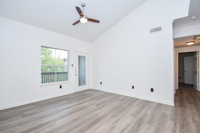 empty room featuring high vaulted ceiling, light hardwood / wood-style floors, and ceiling fan