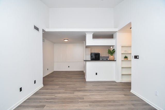 unfurnished living room with hardwood / wood-style flooring