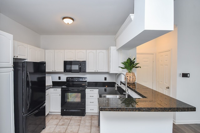 kitchen featuring white cabinetry, sink, black appliances, dark stone countertops, and light tile patterned floors