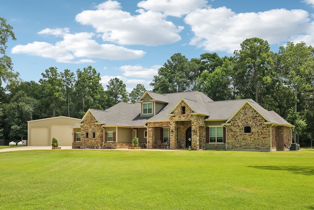 view of front of home with cooling unit, a garage, and a front yard