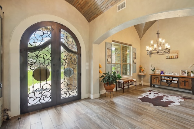 entrance foyer featuring wooden ceiling, french doors, a healthy amount of sunlight, and hardwood / wood-style flooring