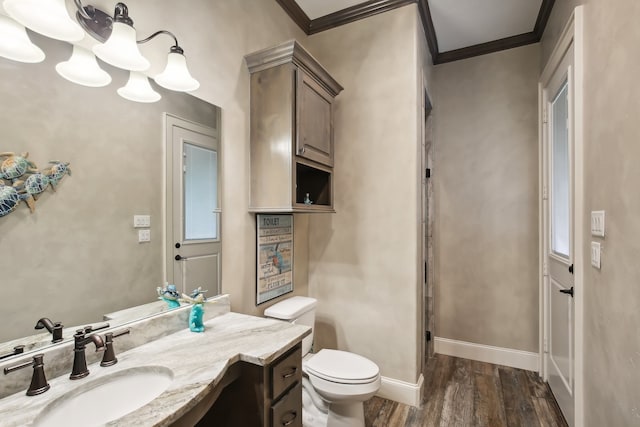 bathroom with hardwood / wood-style flooring, vanity, ornamental molding, and toilet