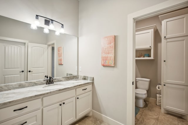 bathroom with tile patterned floors, vanity, and toilet