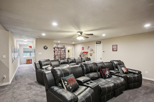 carpeted cinema with ceiling fan and a textured ceiling