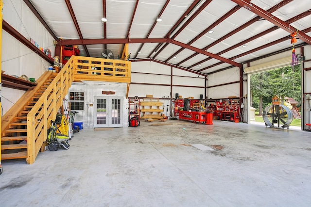 garage with a workshop area and french doors