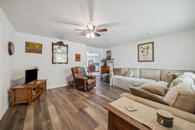 living room with dark hardwood / wood-style floors, a textured ceiling, and ceiling fan