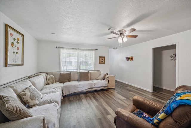 living room featuring a textured ceiling, wood-type flooring, and ceiling fan